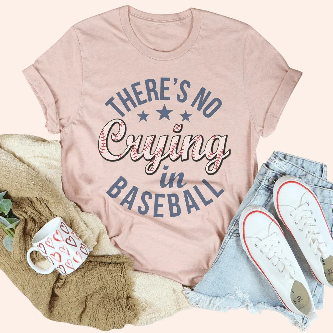 Bleacher Babe pink graphic tee with "There's No Crying in Baseball" text and baseball stitching detail.