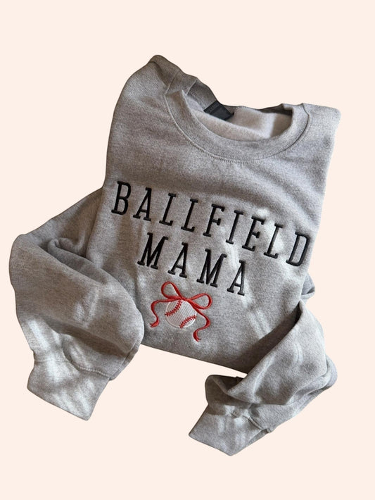 Bleacher Babe grey embroidered sweatshirt with "BALLFIELD MAMA" text and baseball graphic. Soft cotton blend.