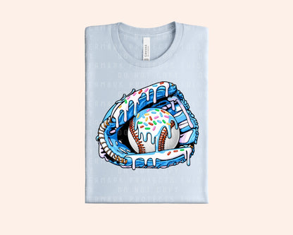 Bleacher Babe light blue graphic tee with a baseball glove holding a baseball covered in blue icing and sprinkles.