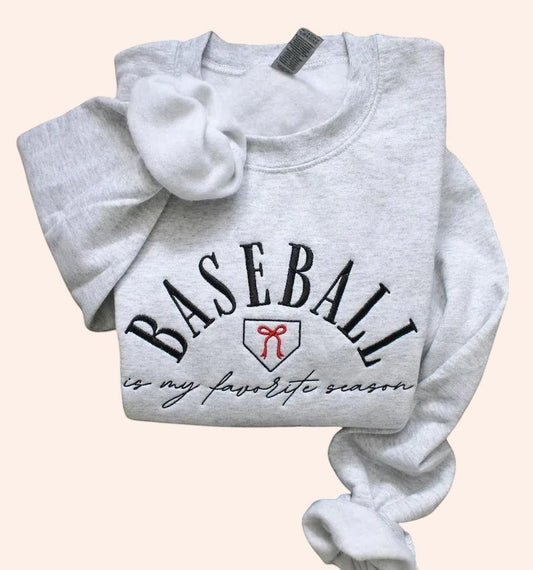Bleacher Babe light grey embroidered crewneck sweatshirt with "BASEBALL is my favorite season" text and baseball home plate graphic.