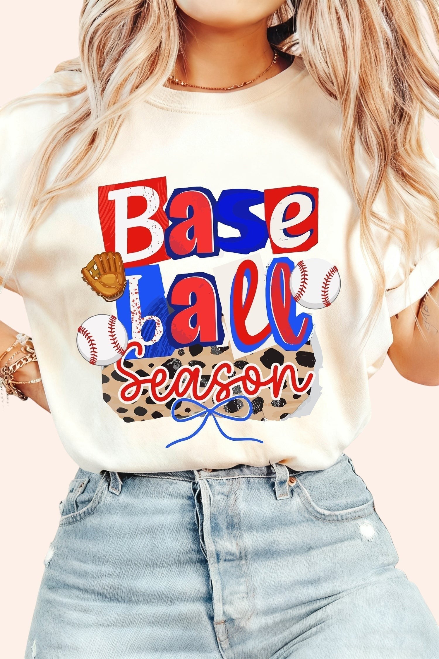 Bleacher Babe cream graphic t-shirt with "Baseball Season" print, baseballs, and glove. Short sleeves, crew neck.