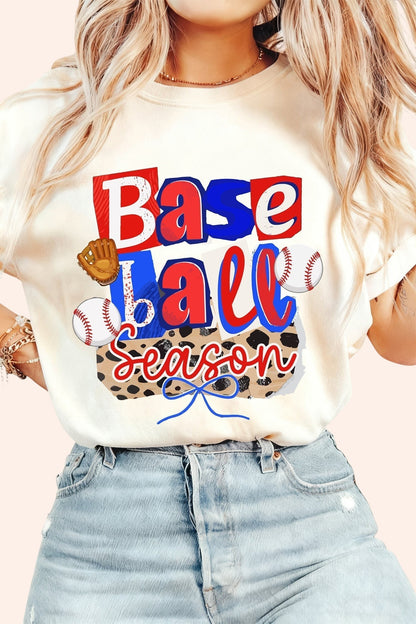 Bleacher Babe cream graphic t-shirt with "Baseball Season" print, baseballs, and glove. Short sleeves, crew neck.
