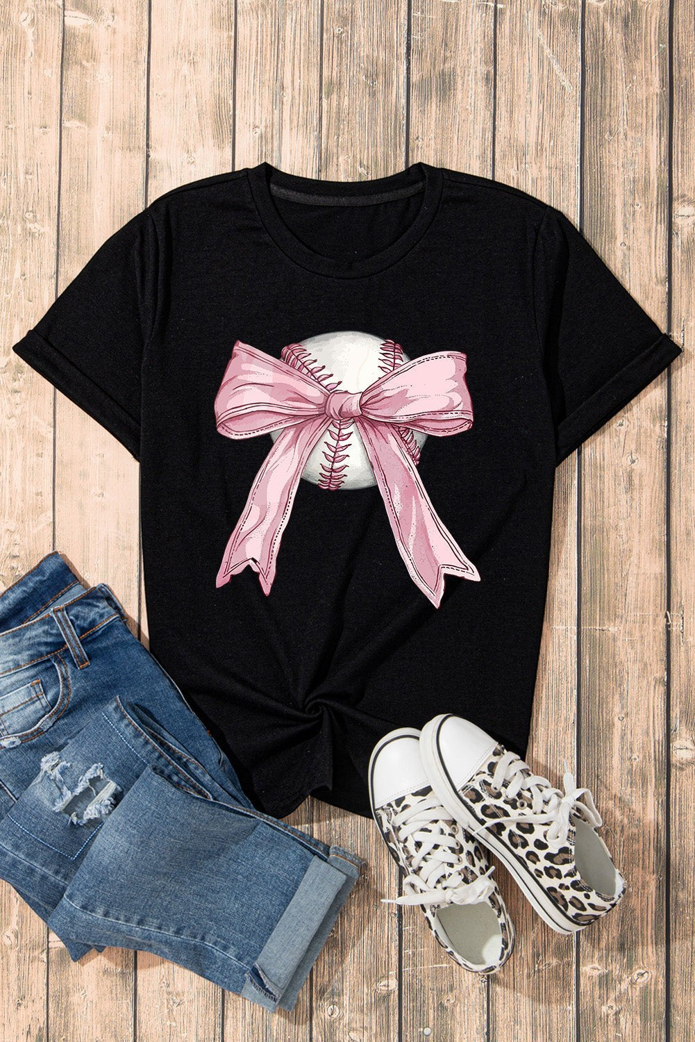 Bleacher Babe black baseball tee with a pink bow graphic on a baseball.