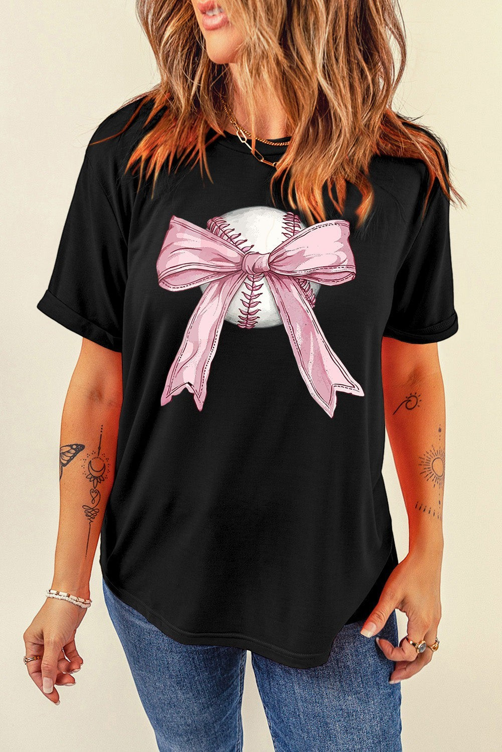 Bleacher Babe black baseball tee with a graphic of a baseball and a pink bow.