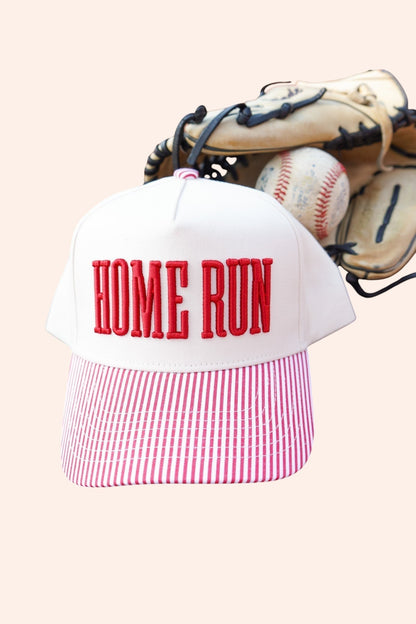 Bleacher Babe Homerun Trucker Hat with white front, red embroidery, and red striped bill. Baseball glove and ball in background.