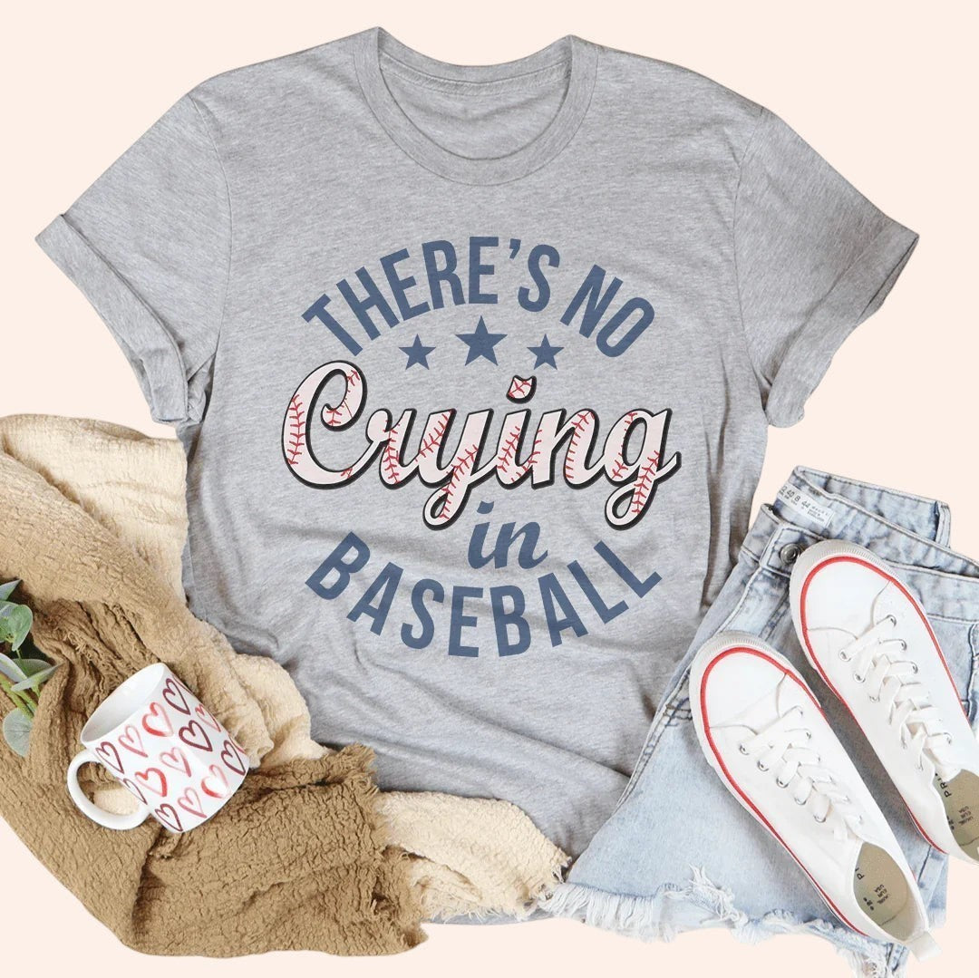 Bleacher Babe grey graphic tee with "There's No Crying in Baseball" text in blue and pink baseball stitching.