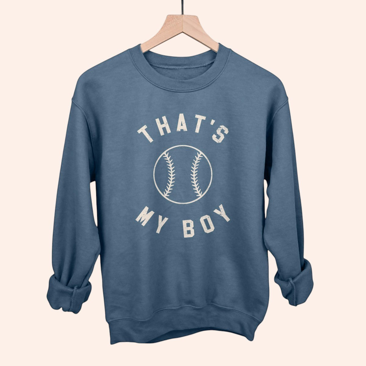 Bleacher Babe blue crewneck sweatshirt with "THAT'S MY BOY" text and baseball graphic. Casual, everyday wear.