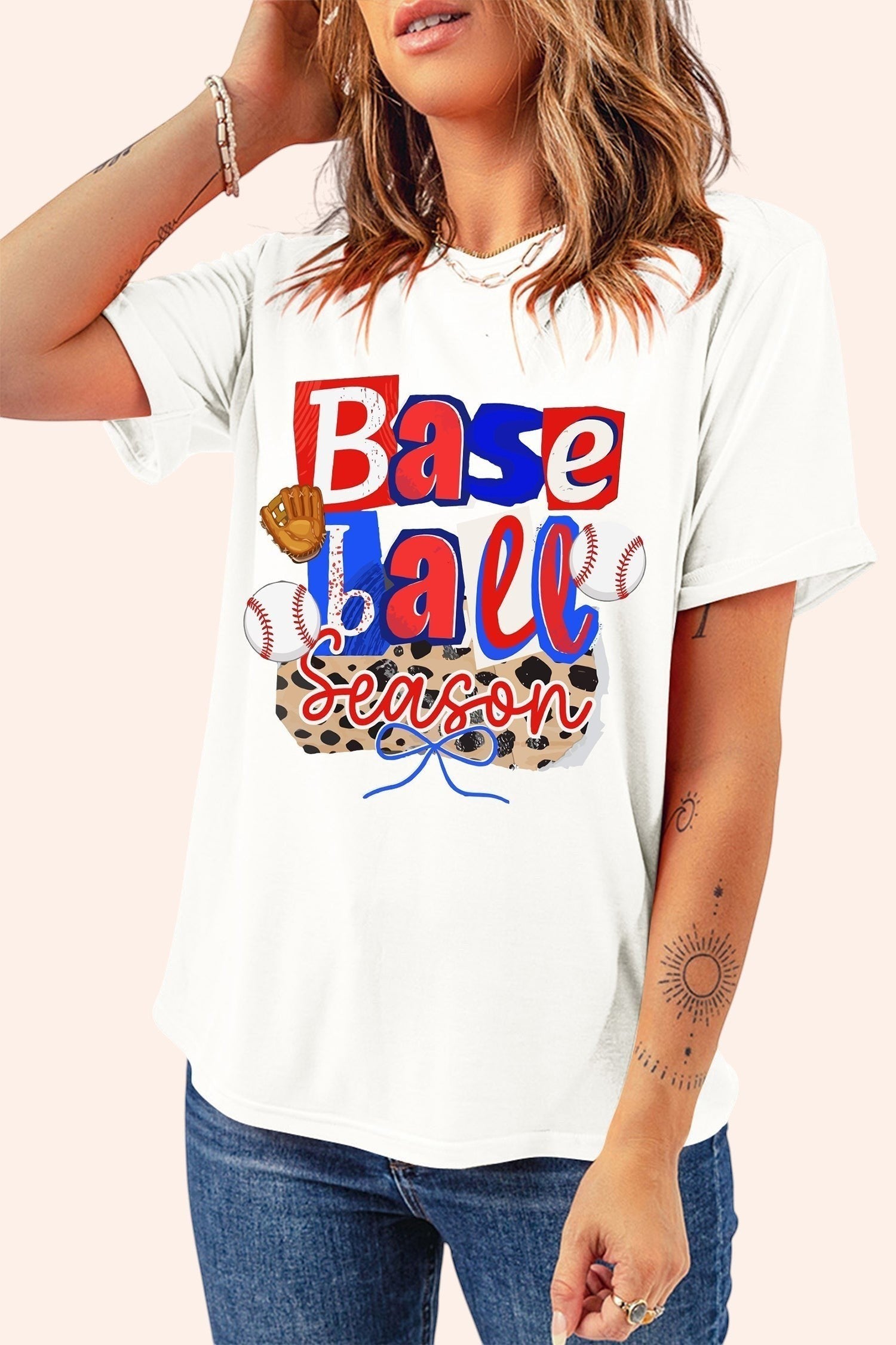 Bleacher Babe white cotton t-shirt with playful "Baseball Season" graphic featuring red, white, and blue lettering, baseballs, and a glove.