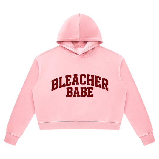 Pink vintage wash cropped hoodie with maroon Bleacher Babe collegiate lettering, front view