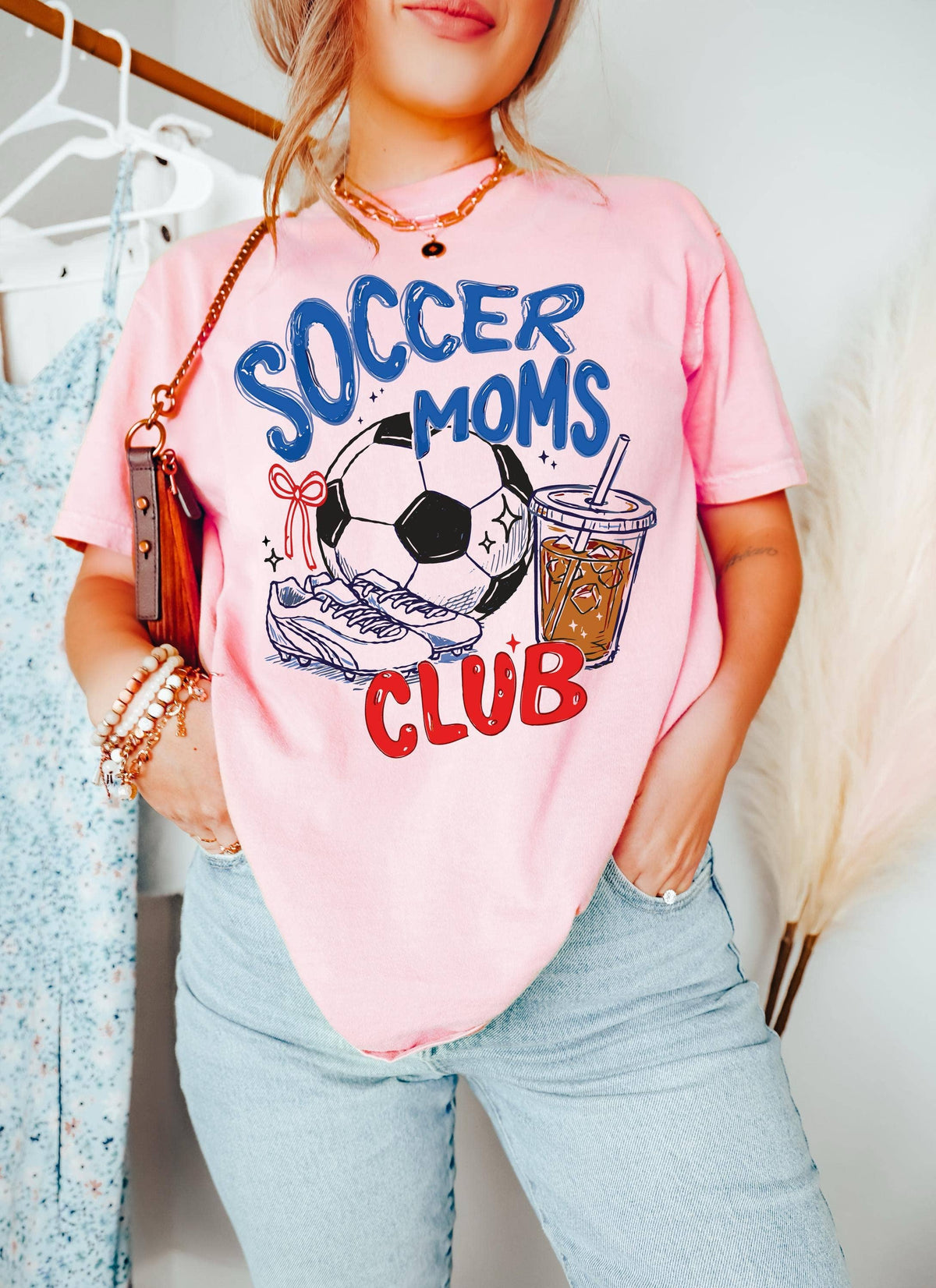 Soccer Moms Club graphic tee in pink styled with jeans for game day